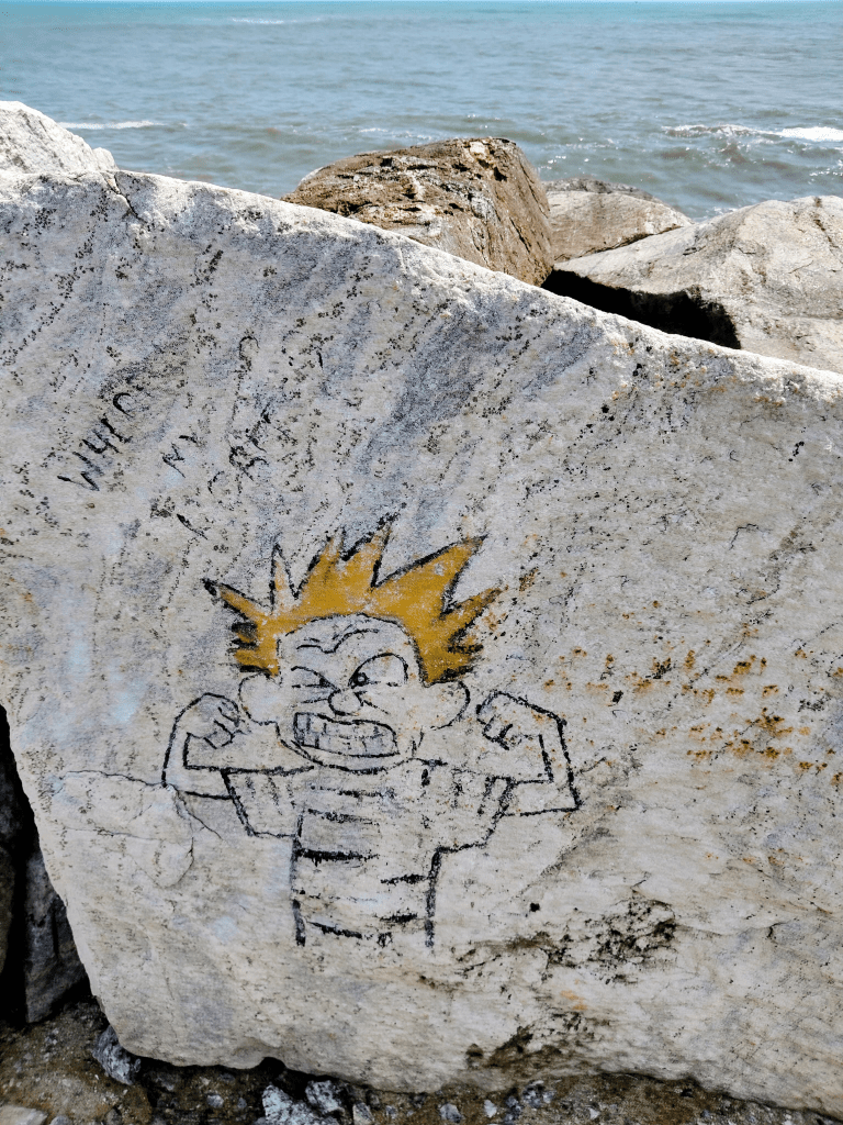 Thangasserry Breakwater Tourism Park. Faded graffiti on a rock.