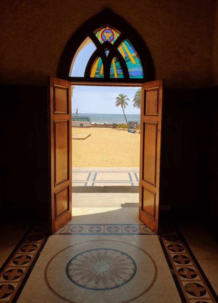 Arabian Sea and the Vettucaud beach, as seen through the open door of Vettucaud Church.